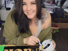 Brittany Grisdale is seen working on one of the handmade doormats that she has been creating and selling through her business Black WolfDog Productions.