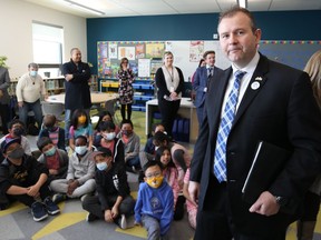 Education Minister Wayne Ewasko (right) walks past students and educators for the Education Action Plan launch at Ecole Templeton School in Winnipeg on Wed., April 20, 2022.  KEVIN KING/Winnipeg Sun/Postmedia Network