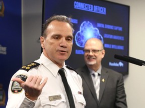 Police Chief Danny Smyth, with Justice Minister Kelvin Goertzen in the background, discusses the Connected Officer program at Winnipeg Police Service headquarters on Mon., April 25, 2022.  KEVIN KING/Winnipeg Sun/Postmedia Network