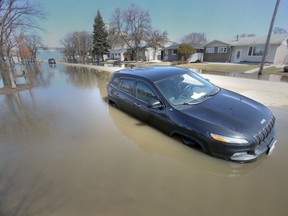 A vehicle surrounded by water on Webster Avenue in Winnipeg on Wednesday, April 27, 2022. Chris Procaylo/Winnipeg Sun