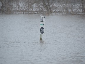 A highway sign in the community of St. Adolphe was submerged by water on Monday, as both overland and river flooding continue to create high water levels in the community, and in much of southern Manitoba. Photo by Dave Baxter /Winnipeg Sun/Local Journalism Initiative