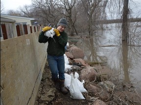 Volunteers on Monday were busy building a structural dike and laying down sandbags, as they work to save the home of Ritchot resident Barb Giesbrecht from being flooded by the rising waters of the Red River. Photo by Dave Baxter /Winnipeg Sun/Local Journalism Initiative