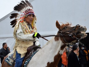 Elder Carl Mazawaciuna takes part in a horse parade on Wednesday, at the kickoff to the 2022 Manito Ahbee Festival at Red River Exhibition Park. Dave Baxter /Winnipeg Sun/Local Journalism Initiative