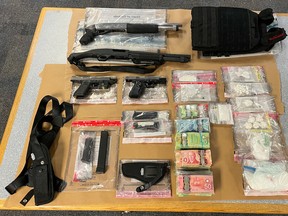 Winnipeg Police Service seized four firearms and a variety of drugs during a raid of a Molson Street residence earlier this week.