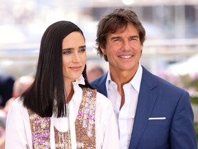 Jennifer Connelly and Tom Cruise attend a cast photo call for "Top Gun: Maverick" during the 75th annual Cannes film festival at Palais des Festivals on May 18, 2022 in Cannes, France.
