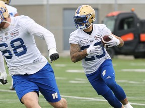 Running back Brady Oliveira (right) runs behind the block off Geoff Gray during the first day of Winnipeg Blue Bombers training camp.