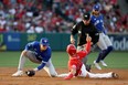 Los Angeles Angels shortstop Andrew Velazquez (4) steals second base ahead of a throw to Toronto Blue Jays second baseman Cavan Biggio.