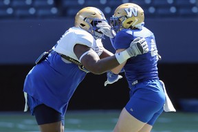 Adam Bighill (right) is blocked by Jermarcus Hardrick during Winnipeg Blue Bombers training camp on Tuesday, May 24, 2022.