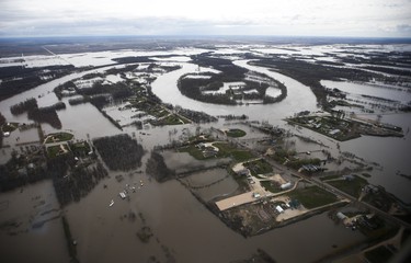 The Red River overflows its banks south of Winnipeg, Sunday, May 15, 2022. John Woods/Pool/The Canadian Press
