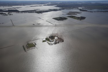 Some properties along Highway 75 are isolated due to Red River flooding south of Winnipeg, Sunday, May 15, 2022. Some sections of the highway are closed south to the United States. John Woods/Pool/The Canadian Press