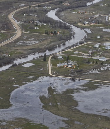 Homes on Peguis First Nation with a Tiger Dam around it for Fisher River flooding north of Winnipeg, Sunday, May 15, 2022. Residents of the community were evacuated. The river levels have dropped considerably this week. John Woods/Pool/The Canadian Press