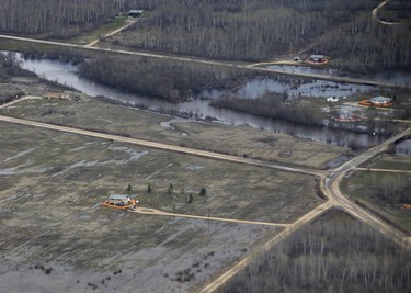 Homes on Peguis First Nation with a Tiger Dam around it for Fisher River flooding north of Winnipeg, Sunday, May 15, 2022. Residents of the community were evacuated. The river levels have dropped considerably this week. John Woods/Pool/The Canadian Press