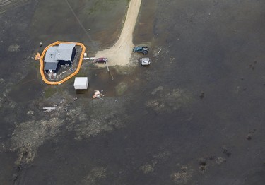 A home on Peguis First Nation with a Tiger Dam around it for Fisher River flooding north of Winnipeg, Sunday, May 15, 2022. Residents of the community were evacuated. The river levels have dropped considerably this week. John Woods/Pool/The Canadian Press