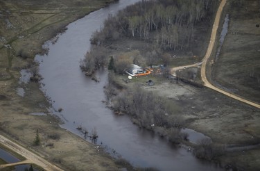 A home on Peguis First Nation with a Tiger Dam around it for Fisher River flooding north of Winnipeg, Sunday, May 15, 2022. Residents of the community were evacuated. The river levels have dropped considerably this week. John Woods/Pool/The Canadian Press