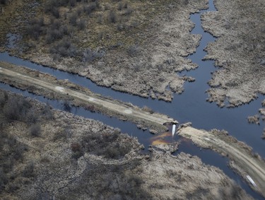 A road has been washed out southeast of Fisher River just north of Winnipeg, Sunday, May 15, 2022. John Woods/Pool/The Canadian Press