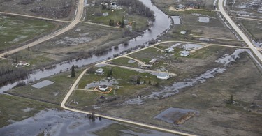Homes on Peguis First Nation with a Tiger Dam around it for Fisher River flooding north of Winnipeg, Sunday, May 15, 2022. Residents of the community were evacuated. The river levels have dropped considerably this week. John Woods/Pool/The Canadian Press