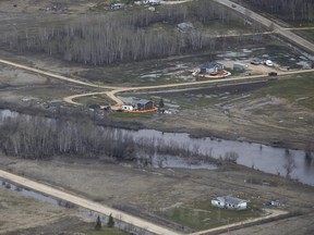 Homes on Peguis First Nation with a Tiger Dam around it for Fisher River flooding north of Winnipeg, Sunday, May 15, 2022. Residents of the community were evacuated.