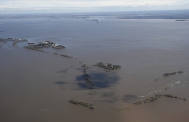 Properties near Emerson, Man., are isolated as a result of the Red River overflowing its banks south of Winnipeg, Sunday, May 15, 2022. John Woods/Pool/The Canadian Press