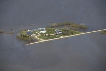 Properties near Emerson, Man., are isolated as a result of the Red River overflowing its banks south of Winnipeg, Sunday, May 15, 2022. John Woods/Pool/The Canadian Press