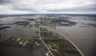 St Adolphe, Man., which runs along highway 75, is protected against Red River flooding by a dike south of Winnipeg, Sunday, May 15, 2022. John Woods/Pool/The Canadian Press