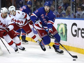 New York Rangers center Filip Chytil controls the puck against Carolina Hurricanes right wing Nino Niederreiter and right wing Jesper Fast during the first period of game six of the second round of the 2022 Stanley Cup Playoffs at Madison Square Garden in New York, May 28, 2022.