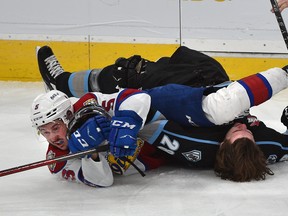 Edmonton Oil Kings Simon Kubicek (5) and Winnipeg Ice Conor Geekie (28) get tangled up on the ice after a collision during WHL action at Rogers Place on Feb. 21, 2022.