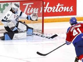 Edmonton Oil Kings’ Tyler Horstmann scores the overtime goal on Winnipeg Ice goalie Gage Alexander last night. James Carey Lauder Photo