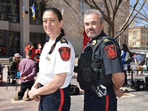 Winnipeg Police Service (WPS) officer Bonnie Emerson, left, and other WPS officers wore temporary red arm badges at an event on Thursday to show support for family and friends of missing and murdered Indigenous women and girls. Dave Baxter/Local Journalism Initiative/Winnipeg Sun