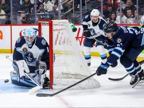Mikey Eyssimont of the Moose tries to score from behind the Milwaukee Admirals net during an AHL playoff game on May 11, 2022.
