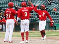 Winnipeg Goldeyes’ Eric Rivera (right) is welcomed at the plate by teammates Raul Navarro and Hidekel Gonzalez after hitting his first professional home run on May 15, 2022, during a 9-7 loss to the Fargo-Moorhead RedHawks 
at Shaw Park in Winnipeg.