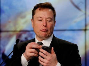 Elon Musk looks at his mobile phone in Cape Canaveral, Florida, January 19, 2020.