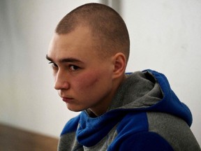 Russian soldier Vadim Shishimarin sits in the defendant's box on the second day of his trial on charges of war crimes for having killed a civilian, at a courthouse in Kyiv, Ukraine, Thursday, May 19, 2022.