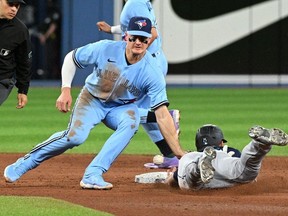 May 18, 2022; Toronto, Ontario, CAN; Toronto Blue Jays third baseman Mark Chapman (26) cannot catch the throw as Seattle Mariners pinch runner Dylan Moore (25) steals second base in the ninth inning at Rogers Centre. Mandatory Credit: Dan Hamilton-USA TODAY Sports