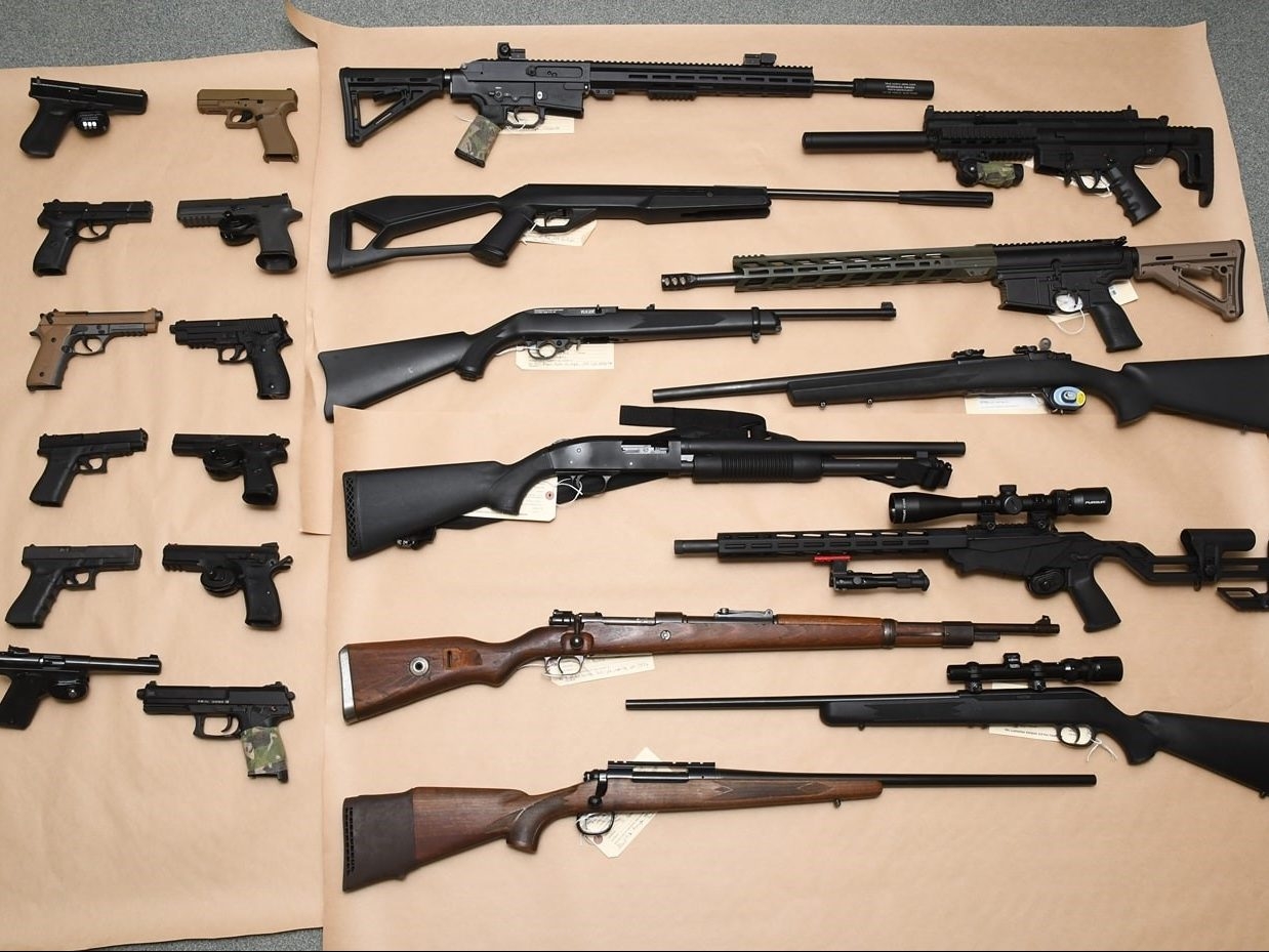 Pair face charges after 19 firearms seized in raid