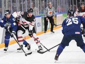 Finland's forward Valtteri Filppula (left) and Canada's forward Pierre-Luc Dubois vie for the puck during the IIHF Ice Hockey World Championships final match between Finland and Canada in Tampere, Finland, on May 29, 2022.
