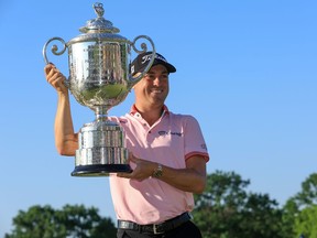 Justin Thomas of the United States poses with the Wanamaker Trophy after putting in to win on the 18th green, the third playoff hole during the final round of the 2022 PGA Championship at Southern Hills Country Club on May 22, 2022 in Tulsa, Okla.
