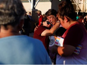 People react a day after a gunman killed 19 children and two teachers at Robb Elementary School, at Uvalde County Fairplex Arena, in Uvalde, Texas, U.S. May 25, 2022.