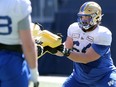 Offensive lineman Liam Dobson is put through a drill during Winnipeg Blue Bombers training camp on Sunday, May 22, 2022.