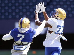 Defensive back Winston Rose (left) gets a hand on receiver Keyion Dixon during Winnipeg Blue Bombers training camp on Tuesday, May 24, 2022. Dixon was among six players released Sunday from Bombers training camp.