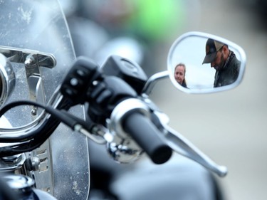 Two participants are reflected in a rear view mirror during the 14th Motorcycle Ride for Dad in Winnipeg on Saturday, May 28, 2022.