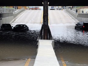 Vehicles sit in the flooded underpass on McPhillips Street north of Logan Avenue in Winnipeg on Tuesday, May 31, 2022.