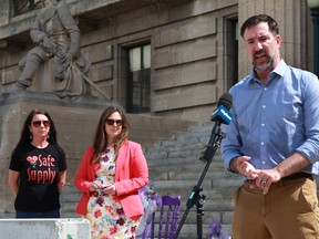 Manitoba Health Coalition executive director Thomas Linner speaks as Coun. Sherri Rollins (middle) and Manitoba regional director of Moms Stop The Harm Arlene Last-Kolb (right) look on during a news conference at the Manitoba Legislature on Monday, June 20.