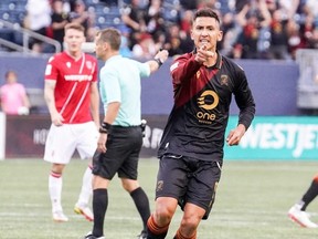 Valour FC's Walter Ponce (right) celebrates after scoring a goal in the second half against Cavalry FC at IG Field in Winnipeg on June 15, 2022.