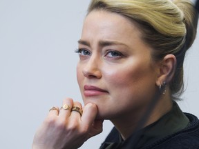 Amber Heard listens to her ex-husband actor Johnny Depp's testimony in the courtroom in the Fairfax County Circuit Courthouse in Fairfax, Va., Wednesday, May 25, 2022.