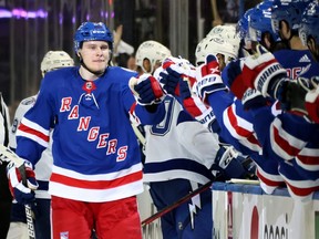 Kaapo Kakko, left, of the Rangers, celebrates with teammates at the bench after scoring a first period goal against the Lightning in Game 2 of the Eastern Conference Final of the 2022 Stanley Cup Playoffs at Madison Square Garden in New York City, Friday, June 3, 2022.