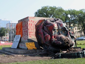 A headless statue of Queen Victoria is seen overturned and vandalized at the provincial legislature in Winnipeg, Friday, July 2, 2021. Her statue and a statue of Queen Elizabeth II were toppled on Canada Day during demonstrations concerning Indigenous children who died at residential schools.