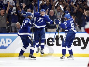 Tampa Bay Lightning left wing Ondrej Palat, middle, celebrates with defenceman Victor Hedman, left, and centre Steven Stamkos, right, after scoring a goal against the New York Rangers during the third period of the Eastern Conference Final of the 2022 Stanley Cup Playoffs at Amalie Arena in Tampa, Fla., June 5, 2022.