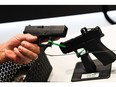 An attendee holds a Glock Ges.m.b.H. pistol during the National Rifle Association (NRA) Annual Meeting at the George R. Brown Convention Center, in Houston, Texas on May 28, 2022. -