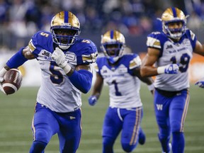 Winnipeg Blue Bombers' Willie Jefferson (5) runs in his interception for the touchdown against the Hamilton Tiger-Cats during the second half of CFL action in Winnipeg, Friday, June 24, 2022.