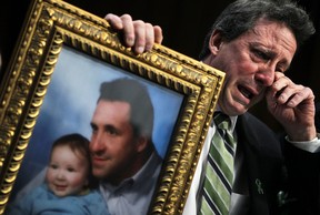 Neil Heslin, father of six-year-old Sandy Hook Elementary School shooting victim Jesse Lewis, wipes tears as he testifies during a hearing before the Senate Judiciary Committee February 27, 2013 on Capitol Hill in Washington, DC.